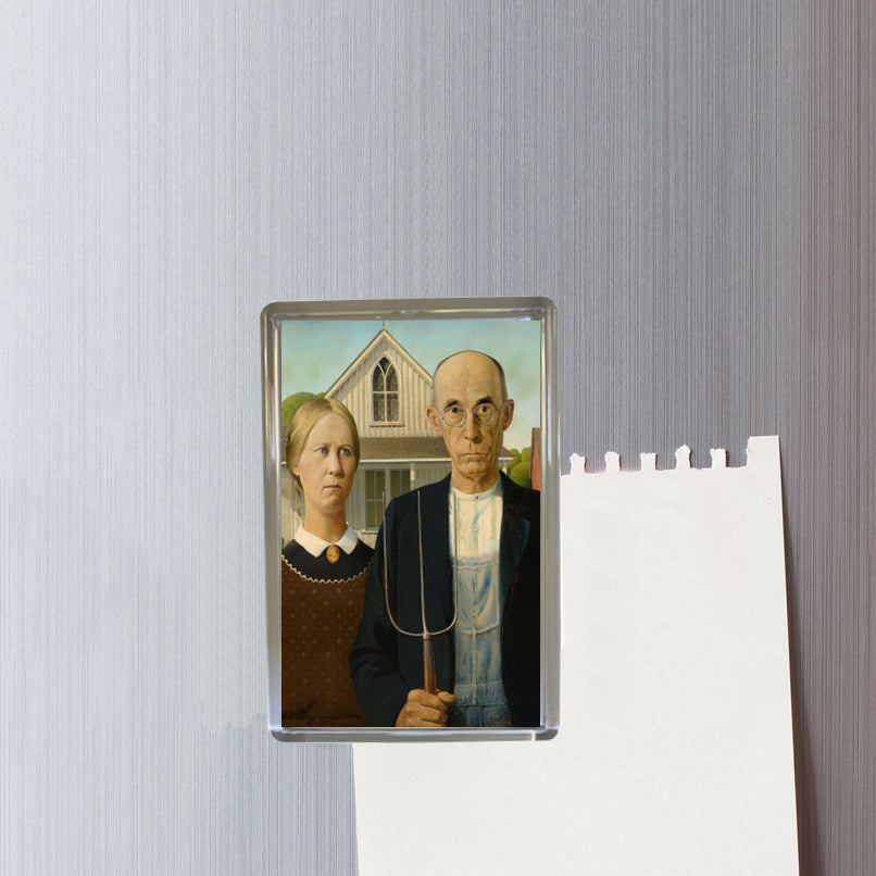Fridge magnet with a portrait of a couple and a house on a textured wall.