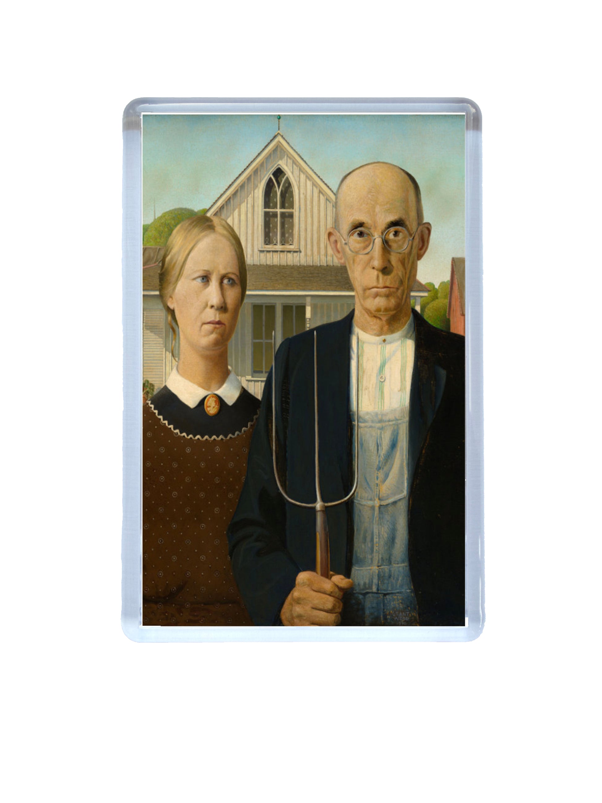 Fridge magnet with a portrait of a man and woman in front of a house, resembling 'American Gothic'.