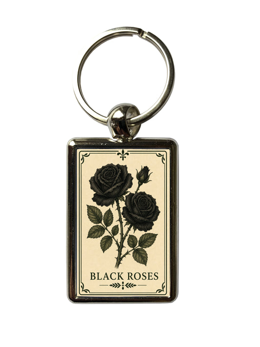 Keychain with black roses design on a beige background