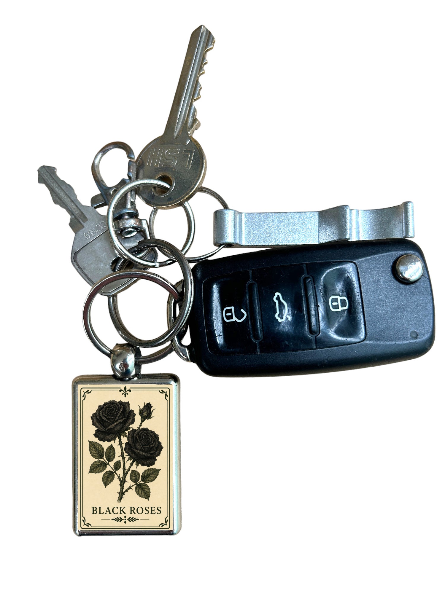 Keychain with black roses design and car key fob on a white background