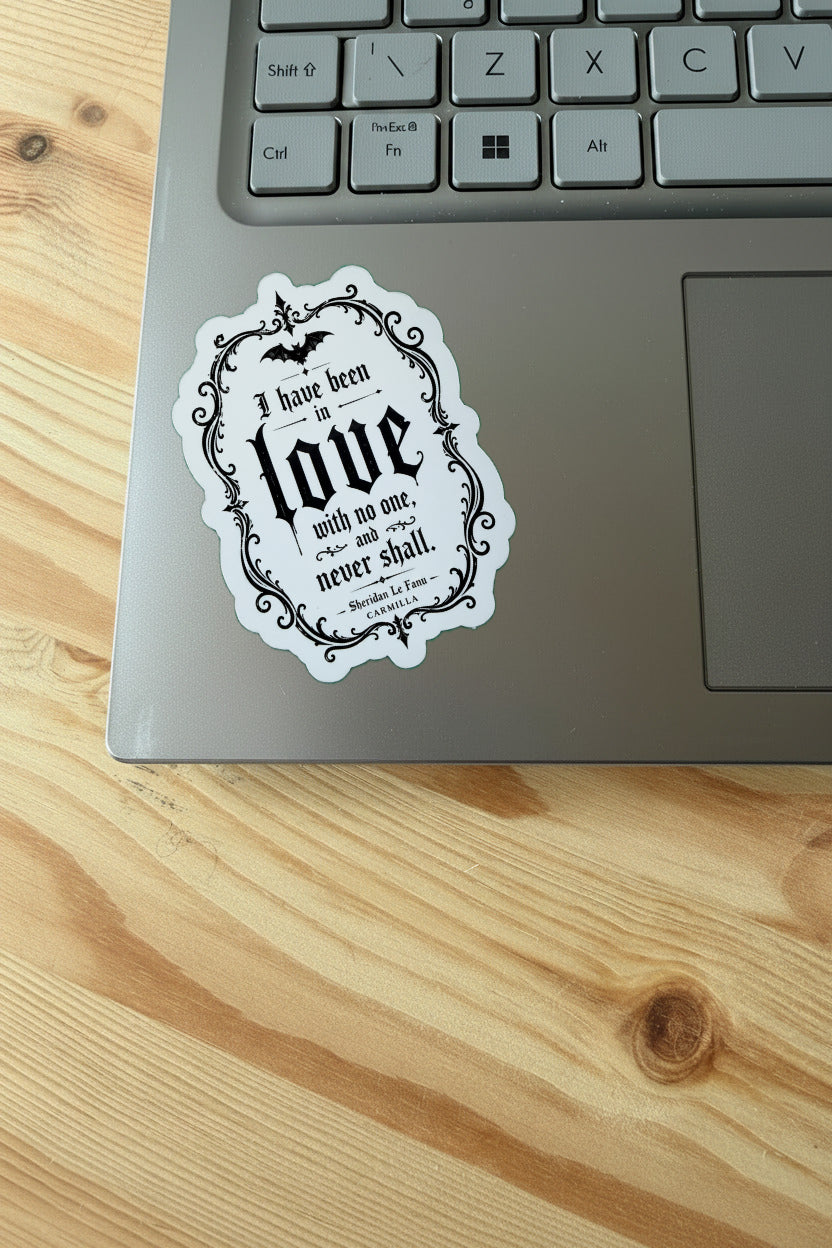 Laptop with a decorative sticker on a wooden surface
