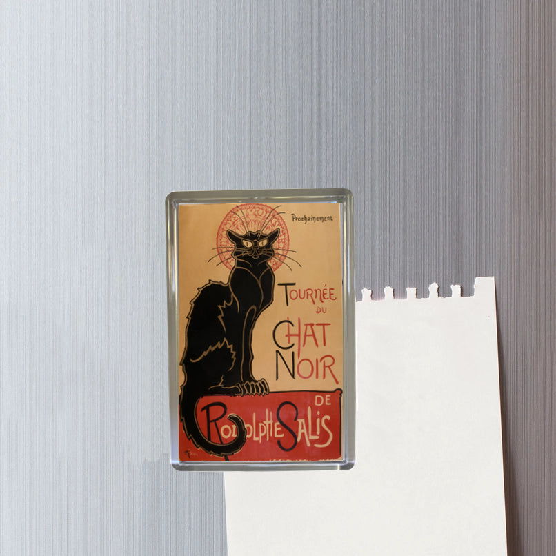 Fridge magnet with a black cat design on a beige background, featuring text, against a textured gray wall.