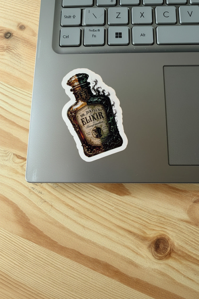 Laptop with a 'Dr. Jekyll's Elixir' bottle sticker on a wooden surface
