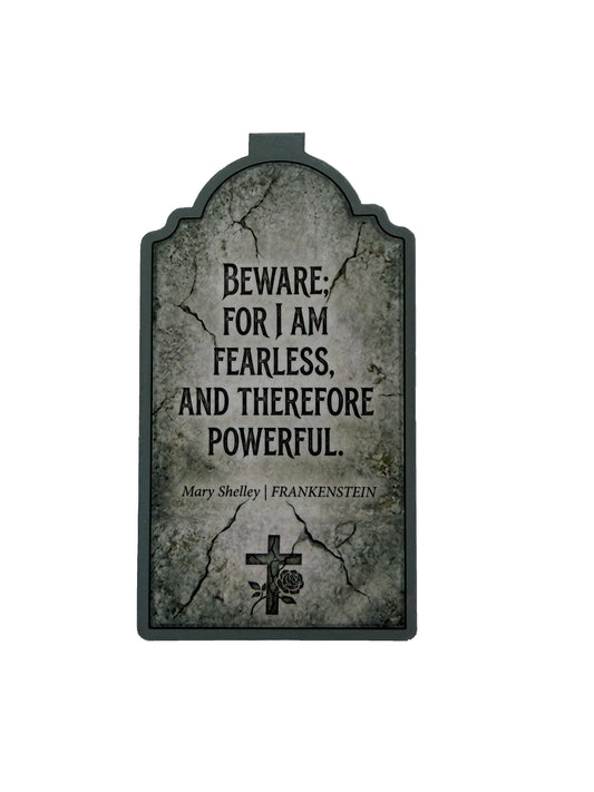 Gothic-style tombstone with text 'Beware: for I am fearless, and therefore powerful.' by Mary Shelley on a white background.