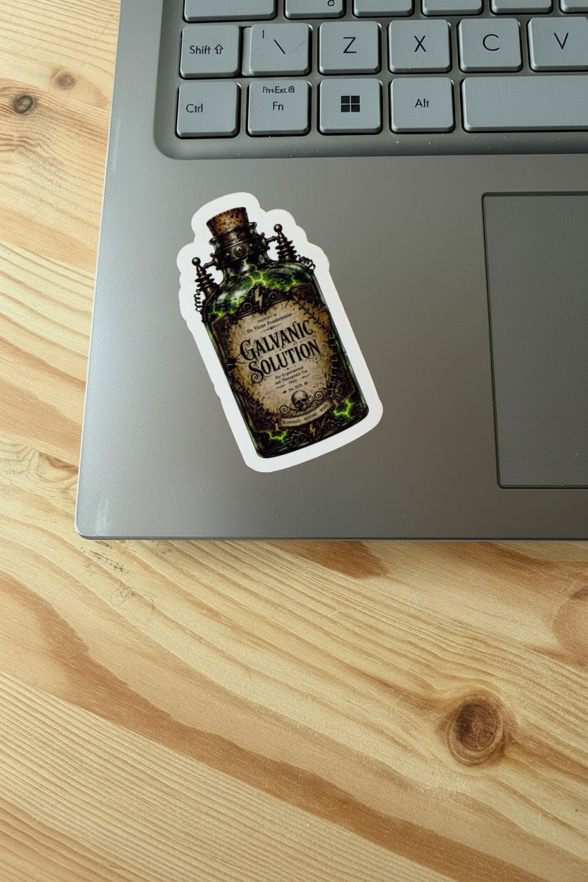 Sticker of a bottle labeled 'Galvanic Solution' on a laptop keyboard.