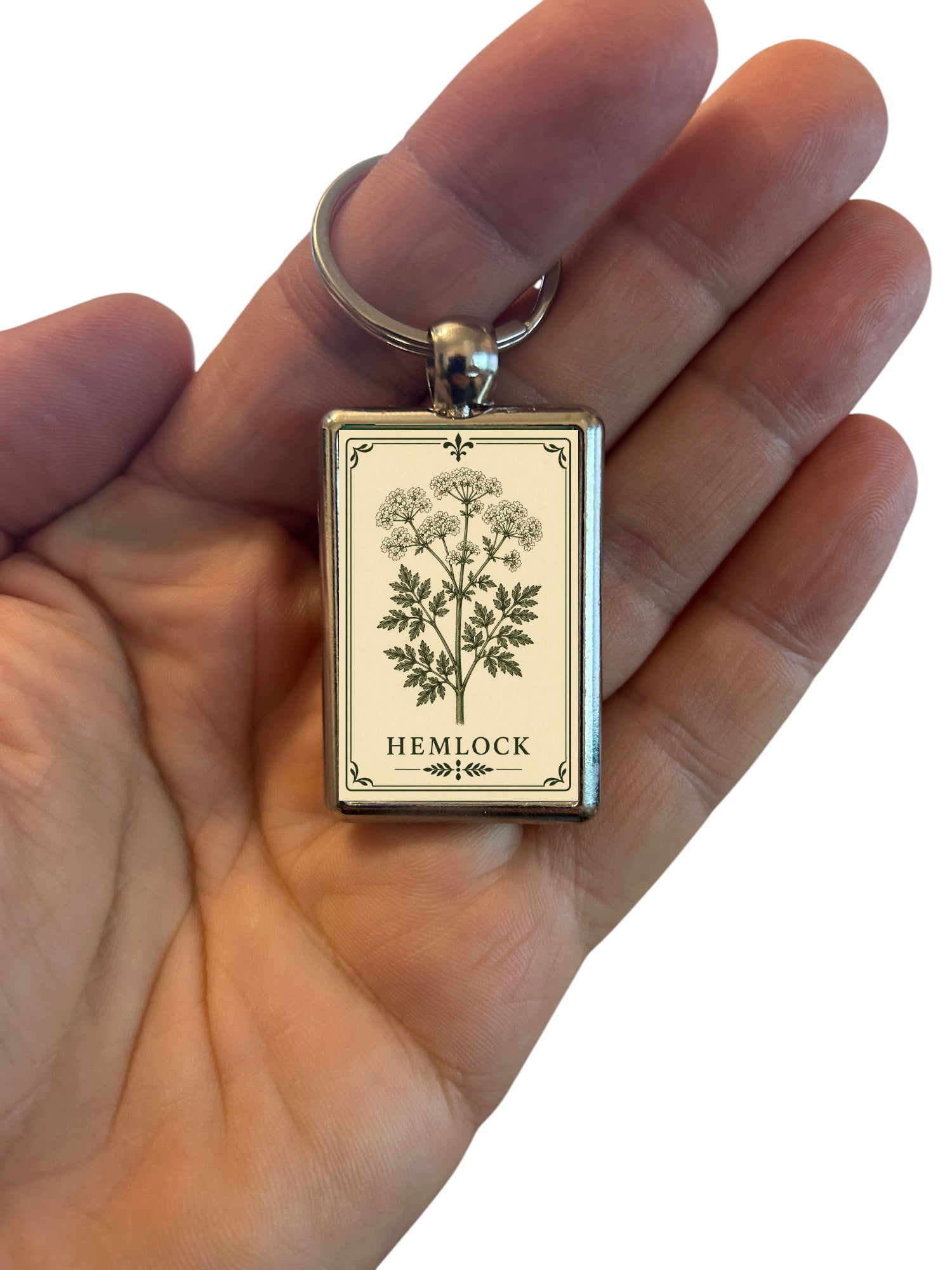 Keychain with 'Hemlock' design held in a hand against a white background