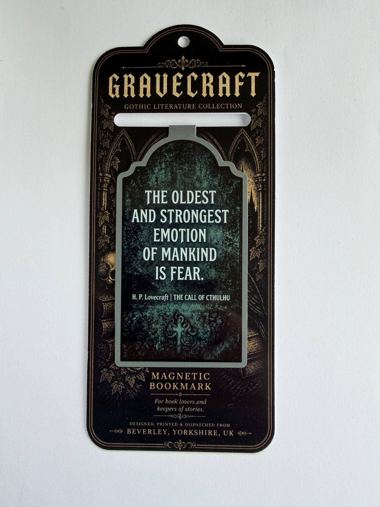 Magnetic bookmark with gothic design and text on a white background