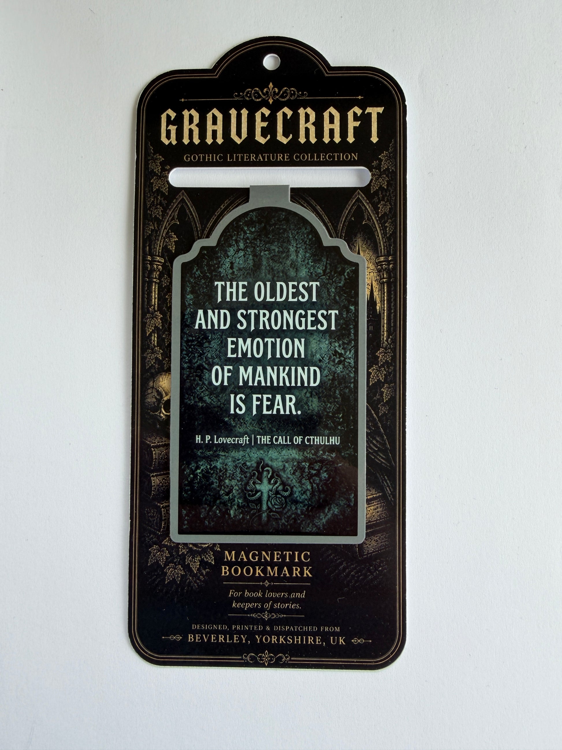 Magnetic bookmark with gothic design and text on a white background