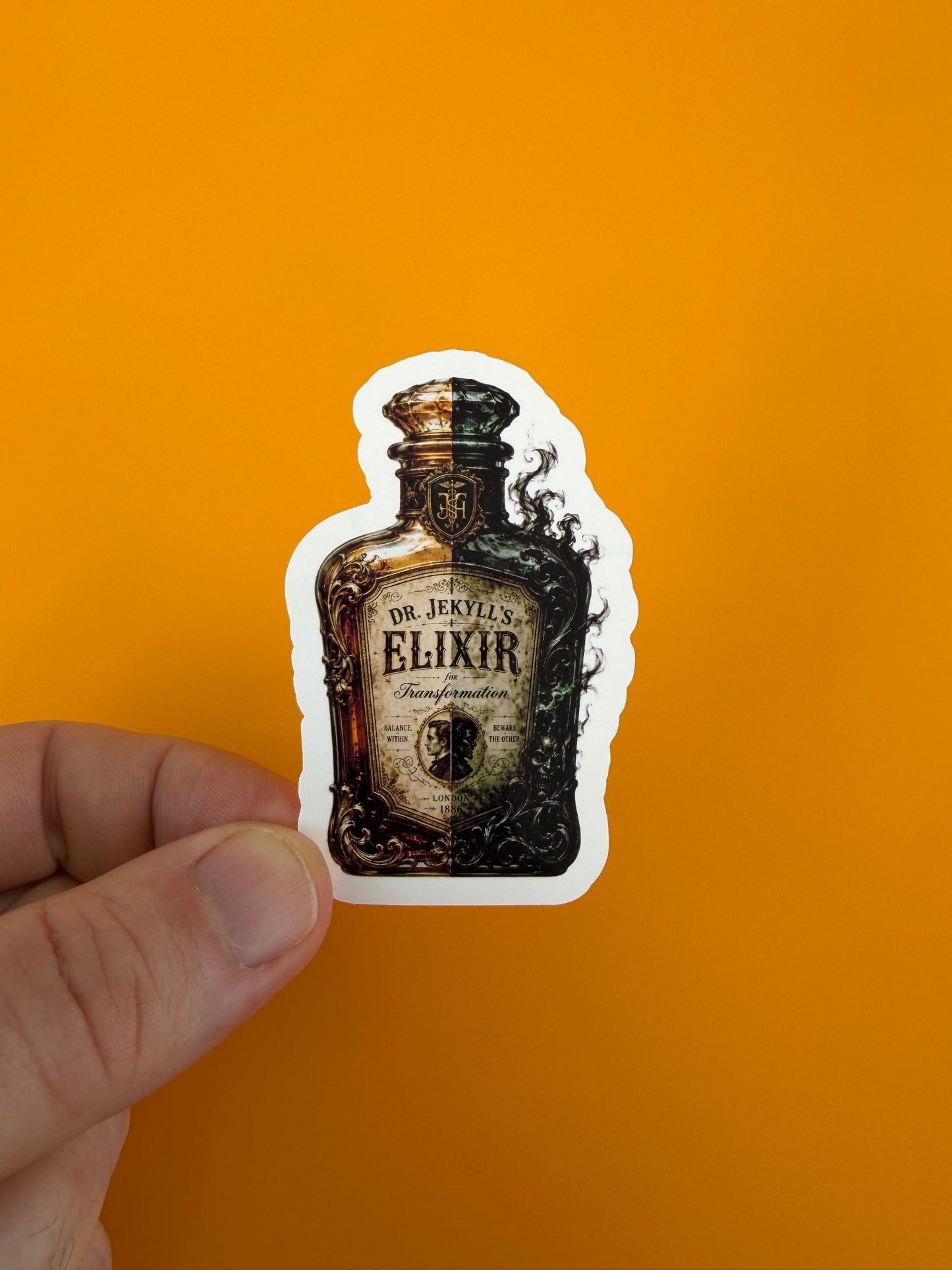'Dr. Jekyll's Elixir' bottle sticker in a hand on orange background
