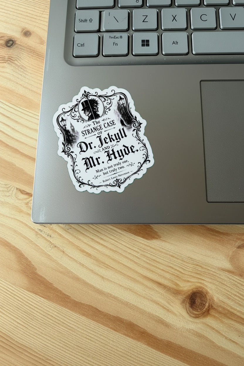 Laptop with a 'Dr. Jekyll and Mr. Hyde' sticker on a wooden surface