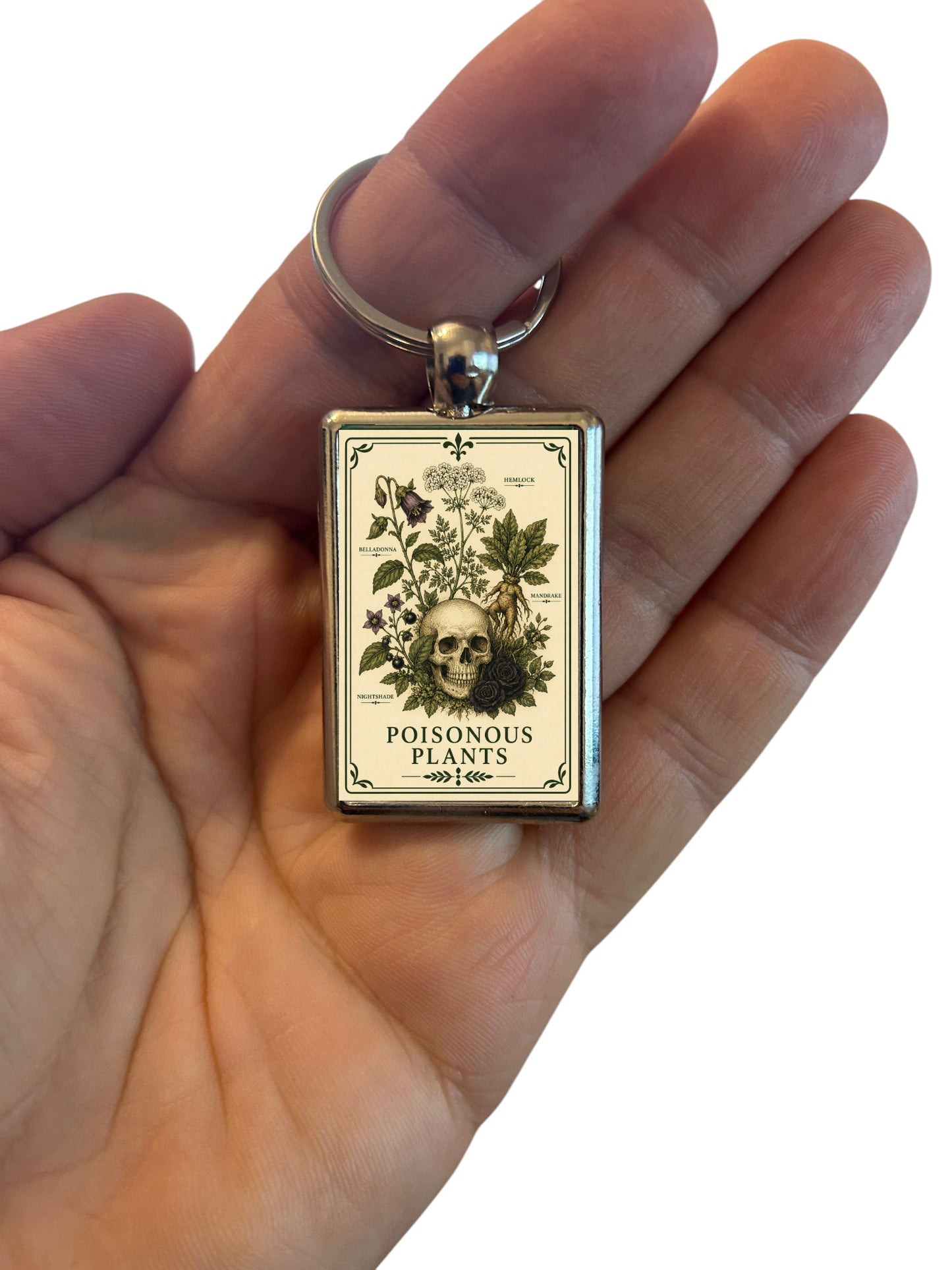 Keychain with a 'Poisonous Plants' label in a hand on a white background