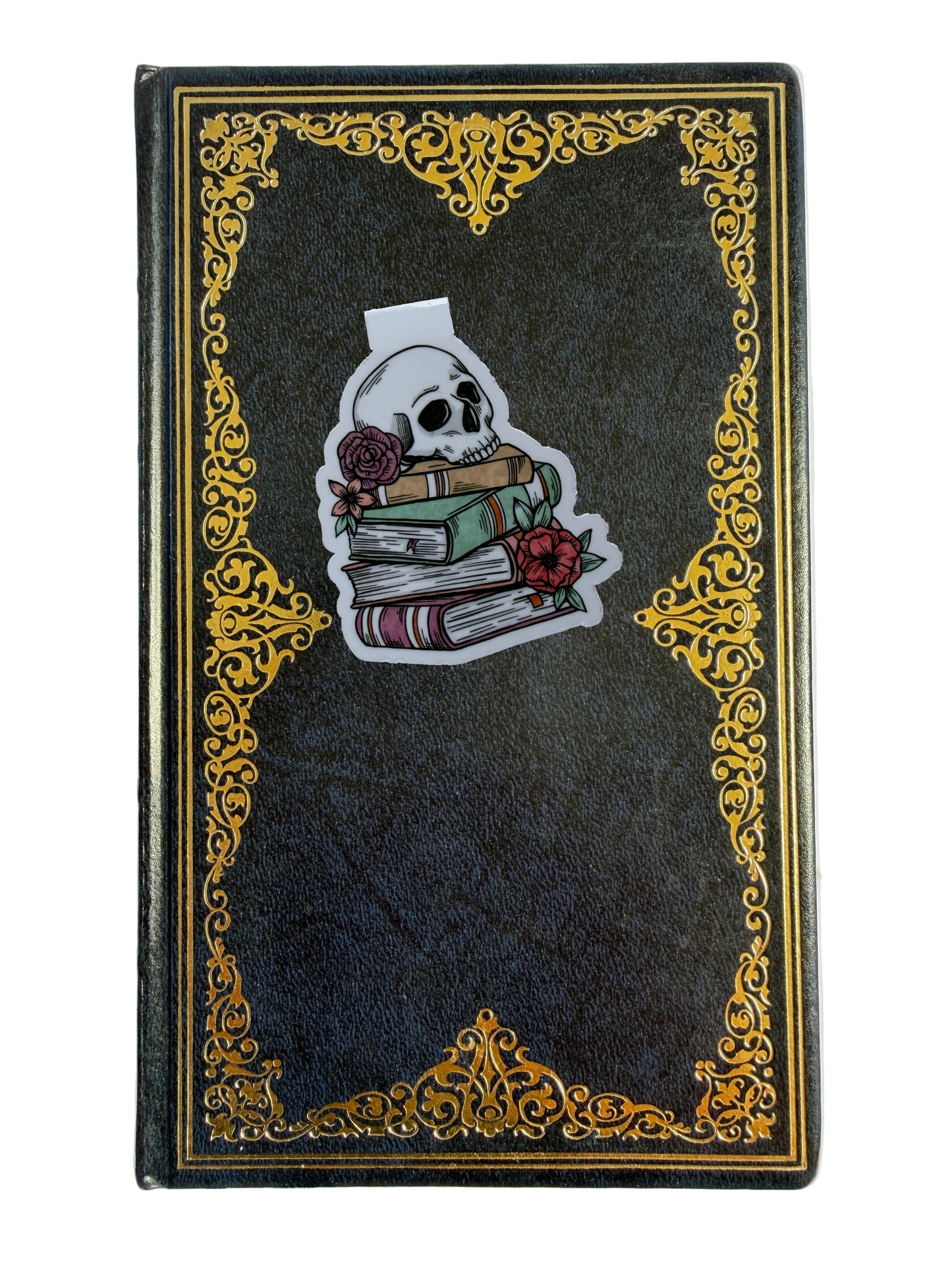 Decorative notebook with skull and books design on a black cover with gold trim