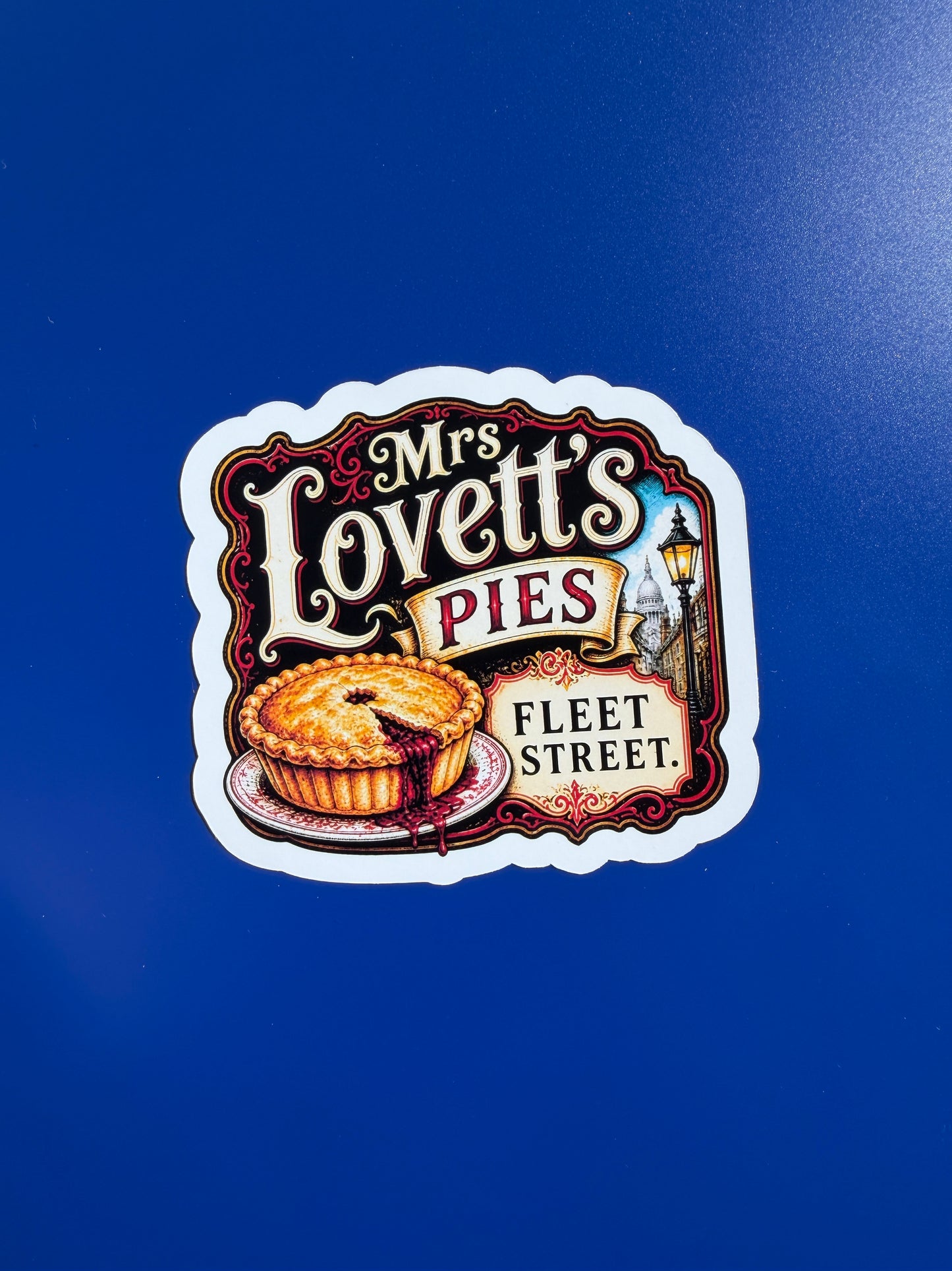 Sticker of Mrs. Lovett's Pies Fleet Street on a blue background